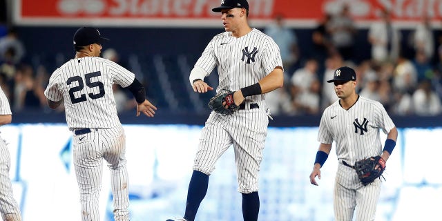 Aaron Judge, center, of the New York Yankees celebrates with teammates Gleyber Torres (25) and Isiah Kiner-Falefa after defeating the Kansas City Royals at Yankee Stadium July 29, 2022, in New York City.