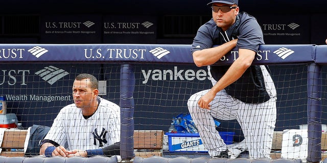#2 Derek Jeter (R) and #13 Alex Rodriguez of the New York Yankees watch from the dugout in the ninth inning against the Detroit Tigers at Yankee Stadium on August 11, 2013 in the Bronx, New York.  