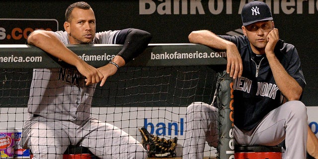 Alex Rodriguez, #13, (L) and Derek Jeter, #2 of the New York Yankees, look on against the Baltimore Orioles in the ninth inning at Oriole Park at Camden Yards on September 11, 2013 in Baltimore, Maryland.