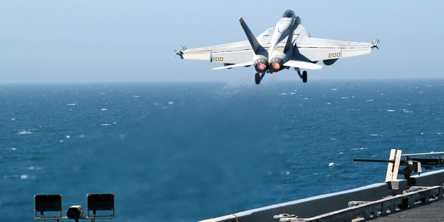 FILE - An F / A-18E Super Hornet is launched from one of four steam catapults on the flight deck aboard the USS Abraham Lincoln.