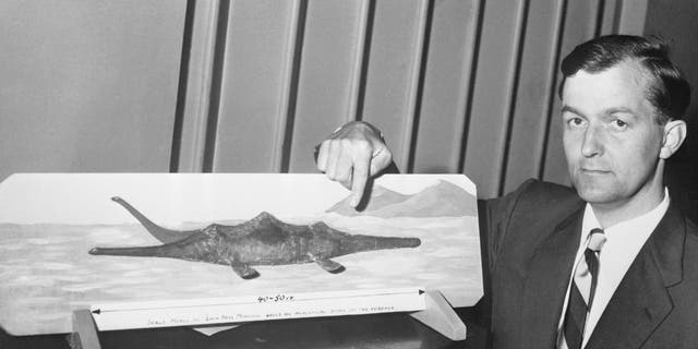 Pilot Tom Dinsdale displays a model he made of the storied Loch Ness "Monster." Dinsdale claims he saw the "monster" and even made movies of it when he was at Loch Ness, Scotland