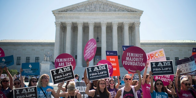 Pro-election and pro-life protesters marched outside the U.S. Supreme Court on Monday, June 20, 2016. 