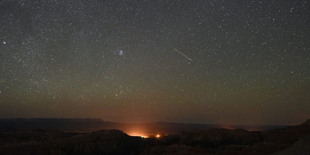 A Perseid meteor streaks across the sky above Inspiration Point early on August 12, 2016, in Bryce Canyon National Park, Utah.