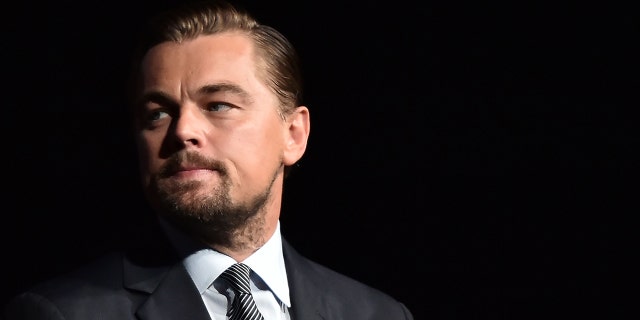 Leonardo DiCaprio looks on before speaking on stage during the Parisian premiere of the documentary film "Before the flood" on October 17, 2016, at the Theater du Chatelet in Paris, before launching a passionate call for immediate action. 