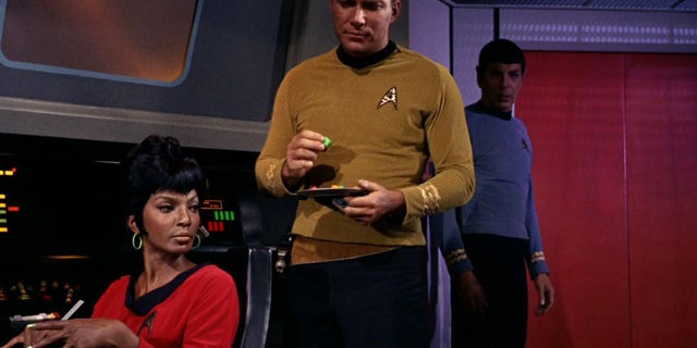 Nichelle Nichols (as Lieutenant Nyota Uhura) and William Shatner (as Captain James T. Kirk) are shown in a scene from "The Man Trap," the premiere episode of "Star Trek" that aired on Sept. 8, 1966.