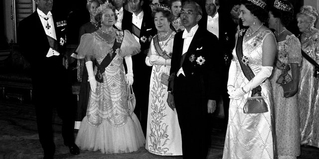 Foreground from left, the Duke of Edinburgh, the Queen Mother, Empress Nagako, Emperor Hirohito and Queen Elizabeth. In the background of the Royal group are, from left, the Duke and Duchess of Kent, the Prince Of Wales, Princess Anne, Lord Snowdon, Princess Margaret (behind the Queen), and extreme right, Princess Alice, Countess of Athlone. The Queen wears the Collar and Grand Cordon of the Supreme Order of the Chrysanthemum, Japan's highest honour; the Emperor wears the Order of the Garter. (Photo by PA Images via Getty Images)