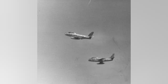 Two F-84 jet fighters (one of many that Lamar flew during his 30-year military career) fly overhead in this 1958 file photo. 