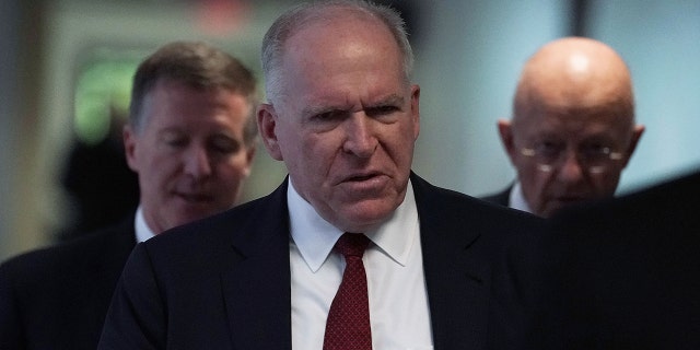 Former CIA director John Brennan, middle, and former director of National Intelligence James Clapper, right, arrive at a closed hearing before the Senate (Select) Intelligence Committee May 16, 2018 on Capitol Hill in Washington, DC. 