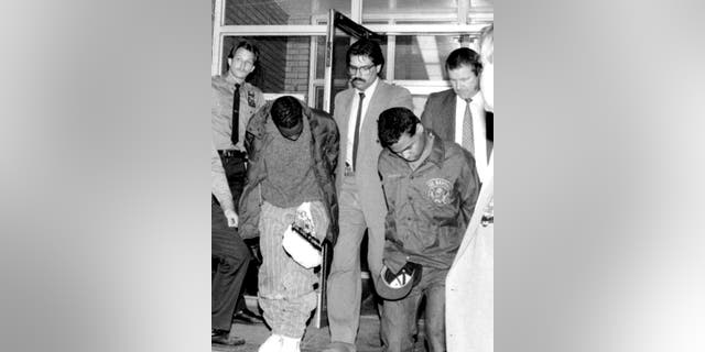 Detectives with then-Central Park Jogger suspects Clarence Thomas (left) and Steven Lopez (right).