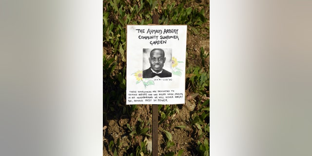 A sign dedicates a sunflower garden to the memory of Ahmaud Arbery at Echo Park during the coronavirus pandemic on May 10, 2020, in Los Angeles, California. 