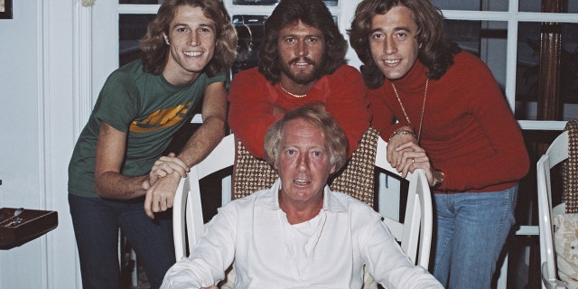 From left: singers Andy Gibb (1958 - 1988), Barry Gibb, and Robin Gibb (1949 - 2012) with Australian music entrepreneur Robert Stigwood (1934 - 2016), February 1979.