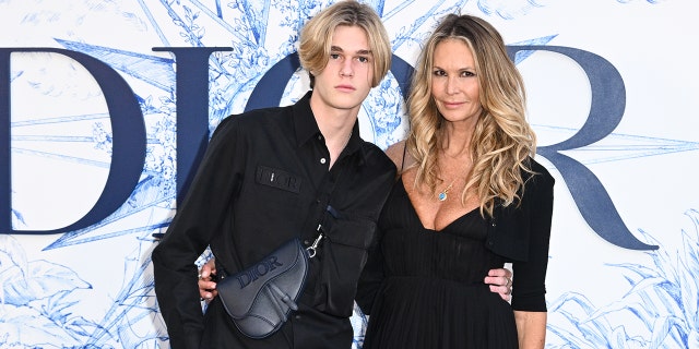 Elle Macpherson and son Cy Busson attend ‘Crucero Collection’ fashion show presentation by Dior at Plaza de España on June 16, 2022, in Seville, Spain.