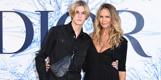 Elle Macpherson and son Cy Busson attend ‘Crucero Collection’ fashion show presentation by Dior at Plaza de España on June 16, 2022, in Seville, Spain. 