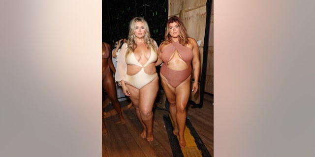 Hunter McGrady, left, and Michaela McGrady pose backstage for Sports Illustrated Swimsuit Runway Show on July 16, 2022, in Miami Beach, Florida.