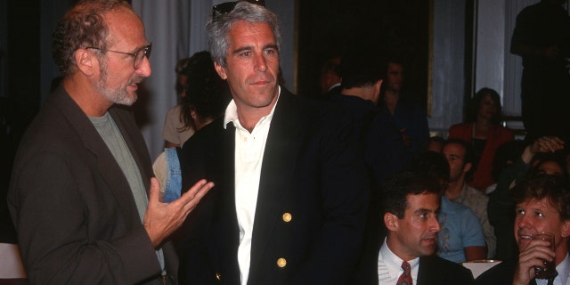 A guest and Jeffrey Epstein attend the Victoria's Secret Fashion Show at the Plaza Hotel on August 1, 1995, in New York City.