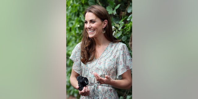 Britain's Catherine, Duchess of Cambridge holds a camera as she takes part in a photography workshop with the charity 'Action for Children' in Kingston, southwest London on June 25, 2019.