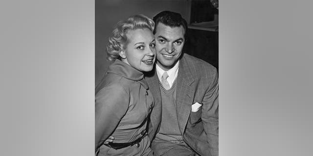 English actress and singer Diana Coupland with singer and composer Monty Norman in London, after the couple announced their engagement, circa 1955.