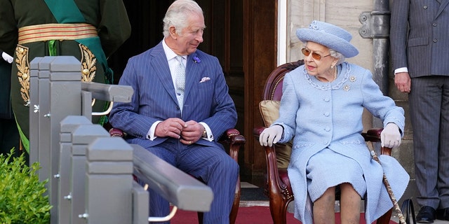 Prince Charles and Queen Elizabeth II attend the Queen's Body Guard for Scotland Reddendo Parade in the gardens of the Palace of Holyroodhouse in Edinburgh on June 30, 2022.