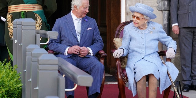 Prince Charles and Queen Elizabeth II attend the Queen's Body Guard for Scotland Reddendo Parade in the gardens of the Palace of Holyroodhouse in Edinburgh on June 30, 2022.