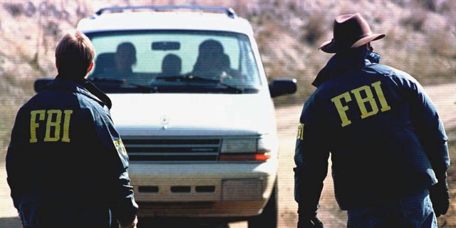 FBI agents guard the entrance to the property of Ted Kaczynski near Lincoln, Montana, on April 5, 1996.