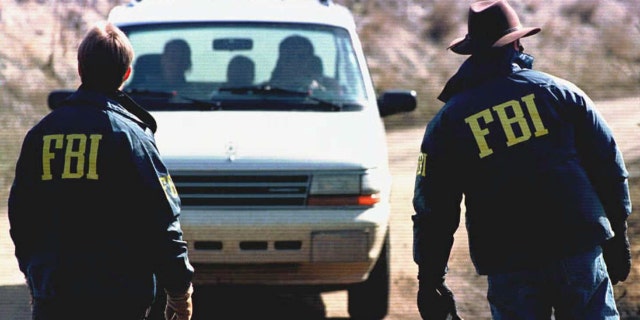 FBI agents guard the entrance to the property of Ted Kaczynski near Lincoln, Montana, on April 5, 1996.
