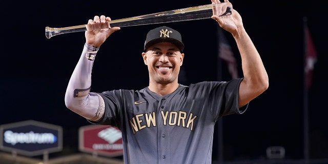 American League's Giancarlo Stanton poses with the Ted Williams Most Valuable Player trophy following the MLB All-Star baseball game, July 19, 2022, in Los Angeles.
