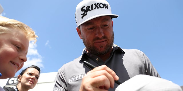 Northern Ireland's Graeme McDowell of Team Niblicks GC, signs a hat for a fan, during day three of the LIV Golf Invitational Series at the Centurion Club, Hertfordshire. Picture date: Saturday June 11, 2022.