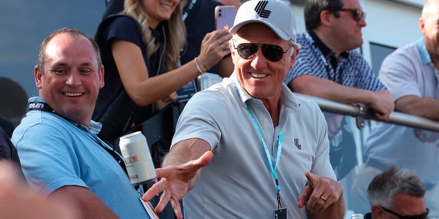 Greg Norman throws a beer at the crowd on the 18th green during the Portland Invitational LIV Golf Tournament on July 2, 2022 in North Plains, Oregon.