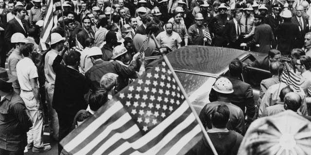 Construction workers among a crowd at a counter demonstration against a student rally, held in the wake of the Kent State shootings in Lower Manhattan, New York City, on May 8, 1970. Workers mobilized by their labor union later attacked the student demonstrators in what became known as the Hard Hat Riot.