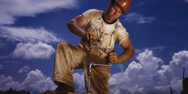 Carpenter working on TVA's Douglas Dam, French Broad River, in Sevier County, Tenn.; Alfred T. Palmer for Office of War Information, June 1942.