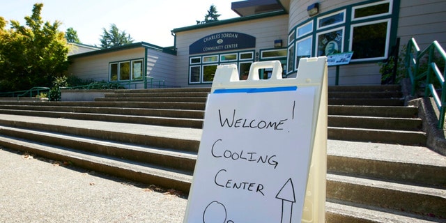A sign showing that a cooling center at the Charles Jordan Community Center is open is shown in Portland, Ore., July 26, 2022. 