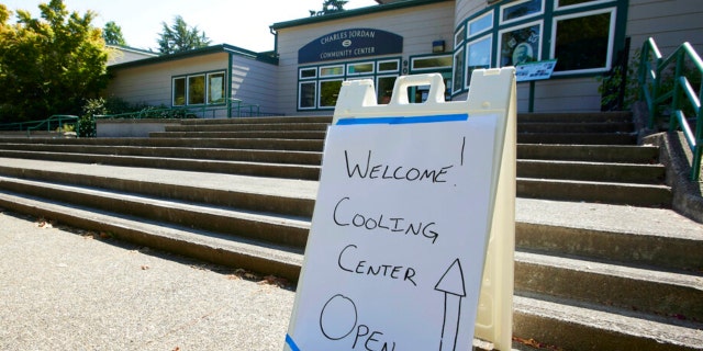 A sign showing that a cooling center at the Charles Jordan Community Center is open is shown in Portland, Ore., July 26, 2022. 