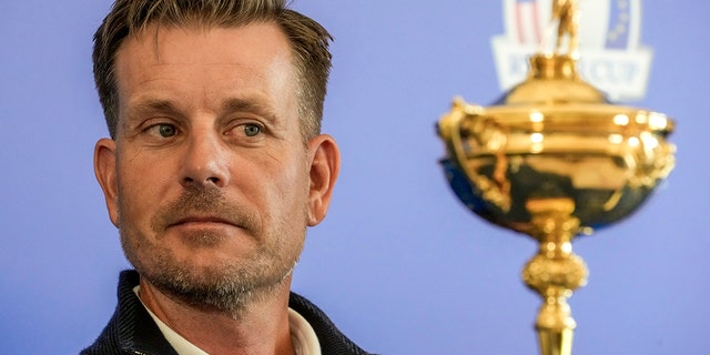 Henrik Stenson looks at the Ryder Cup Trophy during a press conference at the Marco Simone golf club in Guidonia Montecelio, on the outskirts of Rome, Italy, on May 30, 2022.