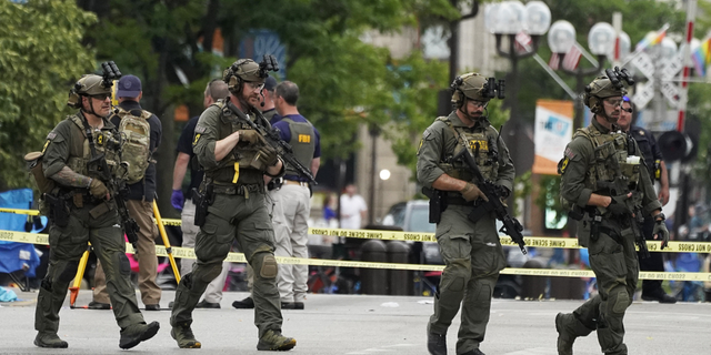 Law enforcement search after a mass shooting at the Highland Park of July Parade in Downtown Highland Park, Ill., a suburb of Chicago, Monday, July 4.