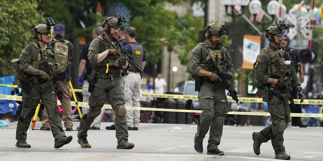 Law enforcement search after a mass shooting at the Highland Park Fourth of July parade in downtown Highland Park, Ill., a suburb of Chicago, on Monday, July 4.