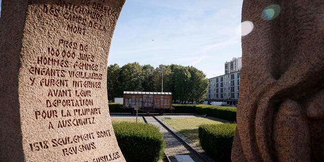 A memorial is pictured near a train car symbolizing the Drancy camp, at the Shoah memorial Tuesday, July 12, 2022 in Drancy, outside Paris. The Paris mayor and head of the French Holocaust Memorial will mark the 80th anniversary of the round-up of the Vel d'Hiv, the biggest Nazi roundup of Jews in France, visiting the site used as an internment camp during World War II for tens of thousands of people who were then sent on to Auschwitz and other death camps.