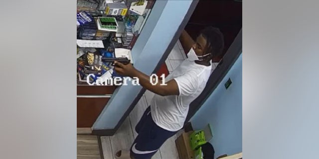 A gunman points a weapon at a store clerk in Houston after he purchased a face mask moments earlier, police said.