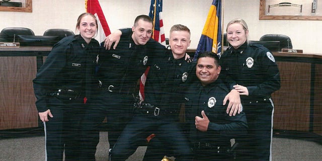 Officer Vasquez (second from right) had served with the police department for nearly two years.