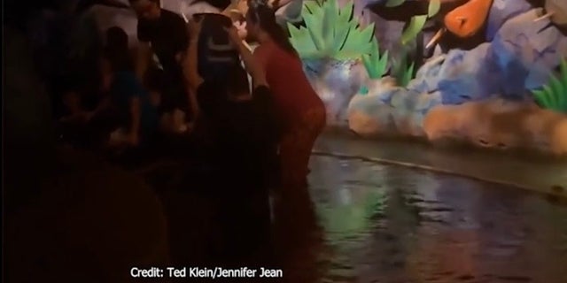 In this screenshot, a Splash Mountain ride vehicle at Disney's Magic Kingdom is beginning to sink with several guests on board.