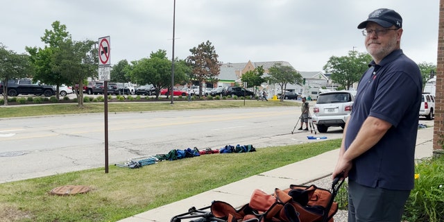 A witness to the Highland Park shooting recounts the tragedy as he picks up items he left behind.