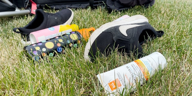 Children's sneakers and sunscreen lay next to lawn chairs left behind following the Highland Park Independence Day parade shooting.
