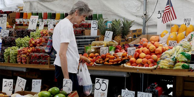 NEW YORK, NEW YORK - JULY 26: A woman picks food in a fresh market on July 26, 2022 in New York. Food prices in the New York area have jumped more than 9% in the last year, is the steepest in the last 40 years, according to the BLS.