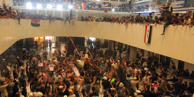Iraqi protesters fill the parliament building in Baghdad, Iraq, Saturday, July 30, 2022.