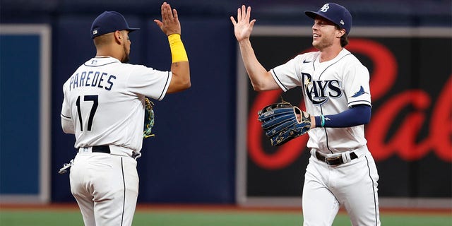 Tampa Bay Rays' Brett Phillips, right, celebrates with Issac Paredes after the team's win over the Boston Red Sox in a baseball game Wednesday, July 13, 2022, in St. Petersburg, Fla. 