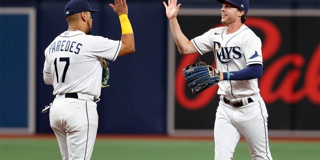 Tampa Bay Rays' Brett Phillips, right, celebrates with Issac Paredes after the team's win over the Boston Red Sox in a baseball game Wednesday, July 13, 2022, in St. Petersburg, Fla.