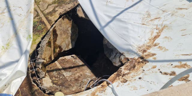 The large sinkhole that opened in the middle of a pool party in Israel is pictured here. One man died after being pulled in while others struggled to get away.