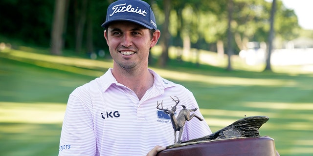 J.T. Poston holds the trophy after winning the John Deere Classic golf tournament, Sunday, July 3, 2022, at TPC Deere Run in Silvis, Ill. 