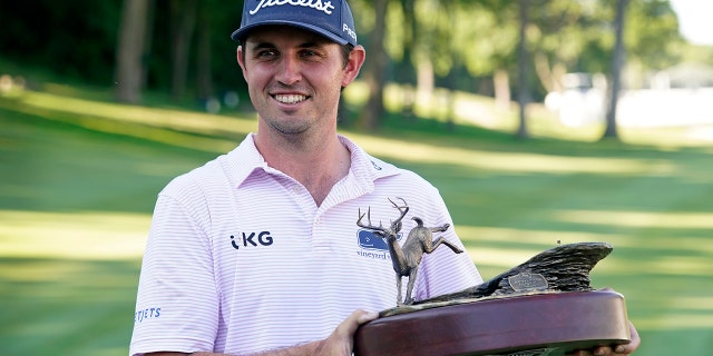 J.T. Poston holds the trophy after winning the John Deere Classic golf tournament, Sunday, July 3, 2022, at TPC Deere Run in Silvis, Ill. 