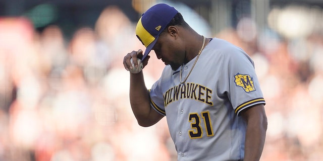Milwaukee Brewers pitcher Jandel Gustave reacts after being called for a balk that scored San Francisco Giants' Wilmer Flores during the eighth inning in San Francisco Saturday, 칠월 16, 2022. 