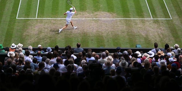 Jannik Sinner of Italy plays a forehand against Novak Djokovic of Serbia during their Men's Singles Quarter Final match on day nine of The Championships Wimbledon 2022 at All England Lawn Tennis and Croquet Club on July 05, 2022 in London, England. 